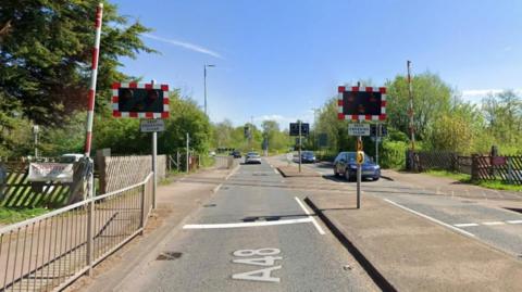 A Google Maps screengrab of Lydney Bypass level crossing, which goes over the A48. The rail tracks go across the road.