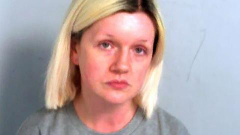 Police mugshot of Virginia McCullough, who has shoulder-length blonde hair with dark roots showing.