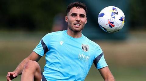 West Bromwich Albion's Tammer Bany stretches his right leg up to control the ball as it flies towards him during a training session