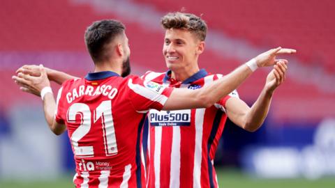 Yannick Carrasco celebrates with Marcos Llorente