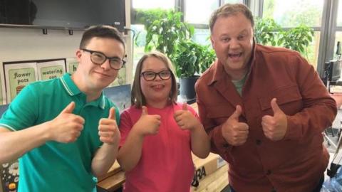 Left to right CBeebies presenter George Webster, pupil Ellie, and children's TV star Justin Fletcher. 