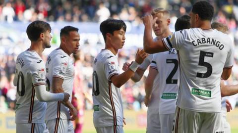 Swansea players celebrate their early goal