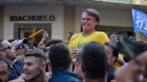 Brazilian right-wing presidential candidate Jair Bolsonaro gestures after being stabbed in the stomach during a campaign rally in Juiz de Fora, Minas Gerais State, in southern Brazil, on September 6, 2018.