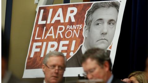 Congressman Paul Gosar held up a large sign with "Liar, Liar, Pants on Fire!!" emblazoned over a picture of Michael Cohen.