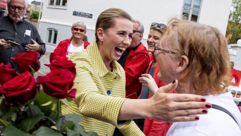 Mette Frederiksen, leader of The Danish Social Democrats gives roses to voters in a last minute campaign in Aalborg, Denmark.