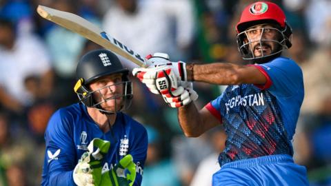 England's Jos Buttler stands up to the stump as Afghanistan's Ikram Alikhil attempts to hit out during their 2023 World Cup match.  