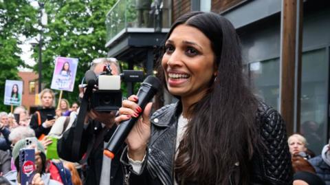 Faiza Shaheen speaks to supporters during a rally