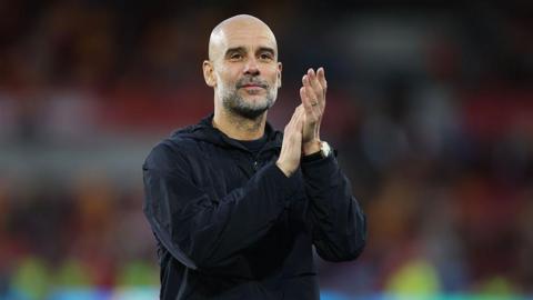 Pep Guardiola applauds the City fans after the win over Brentford