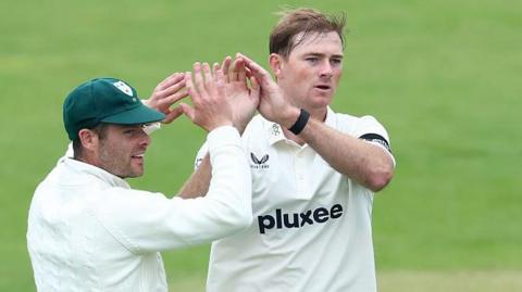 Tom Taylor and Jake Libby celebrate a wicket for Worcestershire