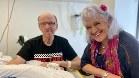 Stroke patient David Goldsmith and actress Kate Dyson sit at David's bedside in the stroke unit at the Royal Sussex County Hospital in Brighton. 