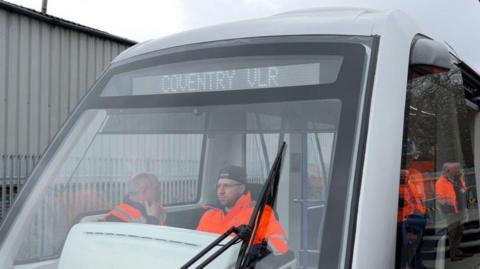 A driver in a Very Light Rail vehicle