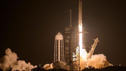 A SpaceX Falcon 9 rocket and Dragon spacecraft lifts off