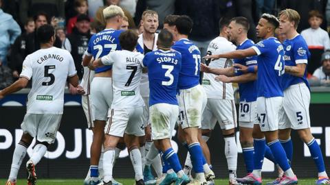 Swansea City and Cardiff City players clash during the derby earlier this season