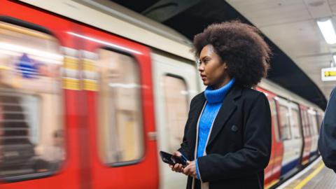 Woman waiting on tube platform