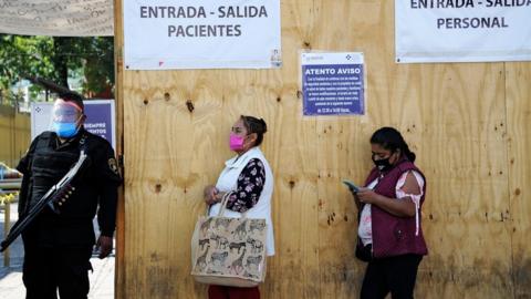 Relatives of patients wait outside a hospital in Mexico City