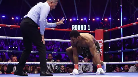 Anthony Joshua puts his hands on the canvas