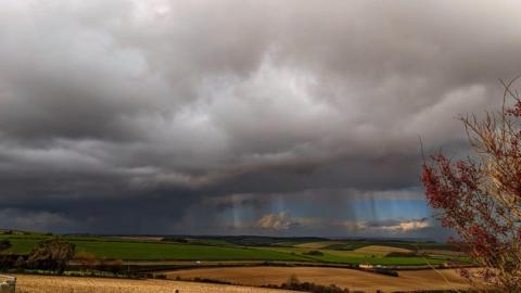 Jerry Rose, Weymouth. Raining over Dorchester.