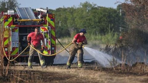 firefighters putting out wildfire