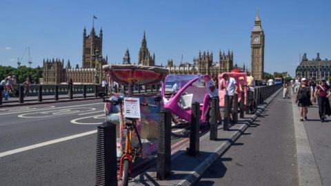 Drivers wait for customers on Westminster Bridge