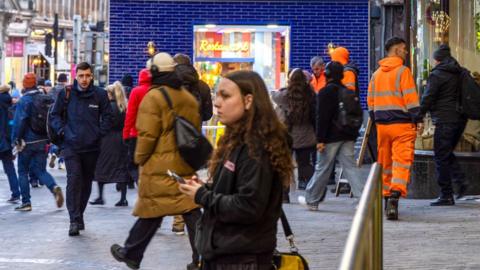 Commuters make their way to work after arriving at Glasgow Queen Street railway station in Glasgow, UK, in January 2024