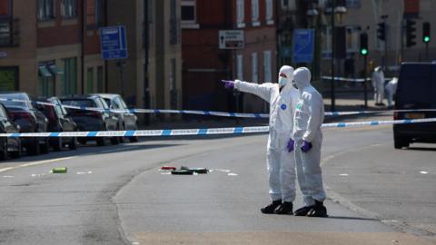 Forensic officers inside a police cordon in Nottingham on the day of the attacks in June 2023. 