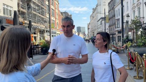 Couple being asked about school uniform policy