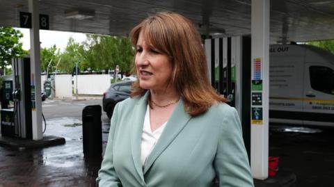 Rachel Reeves speaks to reporters on a petrol station forecourt
