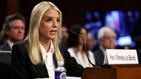 Pam Bondi speaking into a microphone
