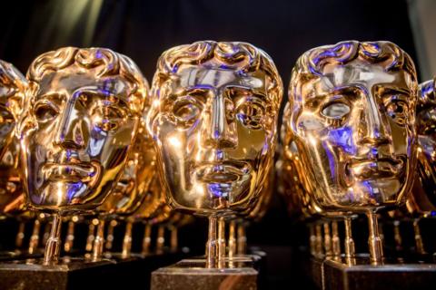 A selection of Bafta statuettes - they are gold faces on stalks