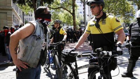 Police facing off with a protester