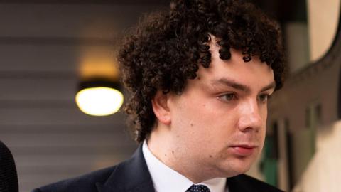 Oliver Steadman leaving Westminster Magistrates' Court wearing a dark blue suit