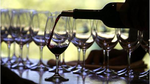 A worker at St. Supery winery pours a glass of wine for a tasting September 20, 2006 in Rutherford, California.