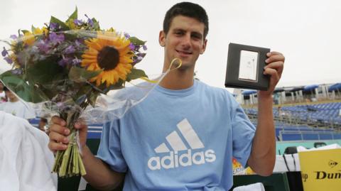 Novak Djokovic holds the trophy after winning his first ATP Tour singles title at the Dutch Open in 2006