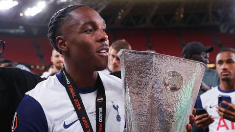 Mathys Tel holding the Europa League trophy