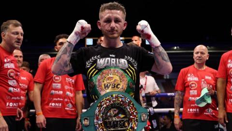 Ryan Garner poses for a photo in the ring after beating Michael Magnesi 
