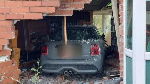 Car embedded in Sandiacre library