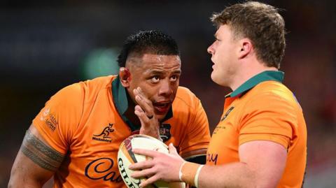Allan Alaalatoa speaks to Australia team-mate Billy Pollard during the first Lions Test in Brisbane