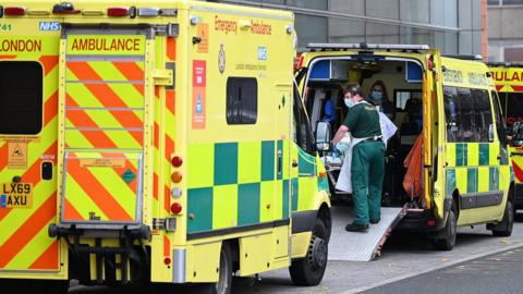 Paramedics move a patient from an ambulance outside the Royal London Hospital