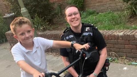 PC Taylor with boy who lent his bike to officer