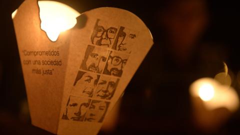 Catholic faithful participate in a procession to commemorate the 26th anniversary, of the murder of Father Ignacio Ellacuria, and five Jesuits priests and two employees, at the Central American University in San Salvador on November 14, 2015