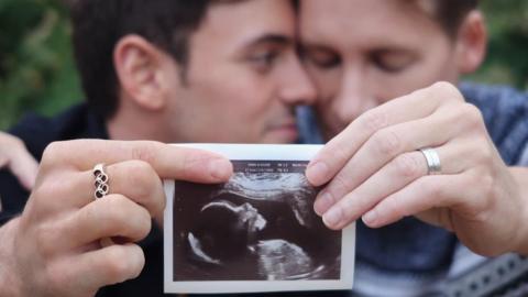 Tom Daley and Dustin Lance Black sharing picture of scan