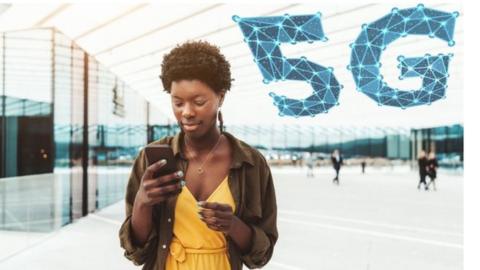 A woman using a mobile phone with a 5G sign