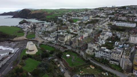 Aerial view of a seaside town, grey skies.