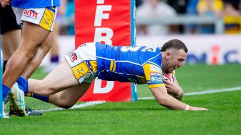 Warrington Wolves player Cameron Smith dives over the line to score a try against Leeds Rhinos.