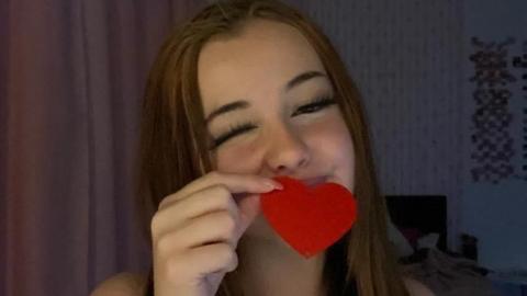 Phoebe Macias holds a small red heart token in a photograph taken before she was found dead at her home in Hastings in July 2024.