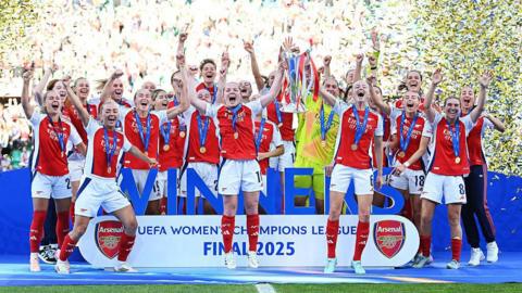 Arsenal Women lifting the Champions League trophy in 2025.