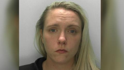 Police mugshot of Chelsea Iles, a woman in her late 20s with long blonde hair, parted at the side.