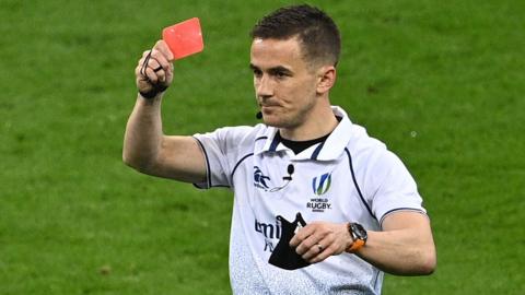 Luke Pearce shows a red card