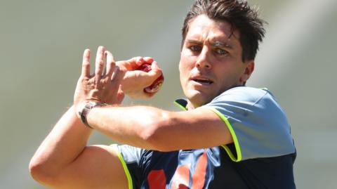 Pat Cummins bowls in training