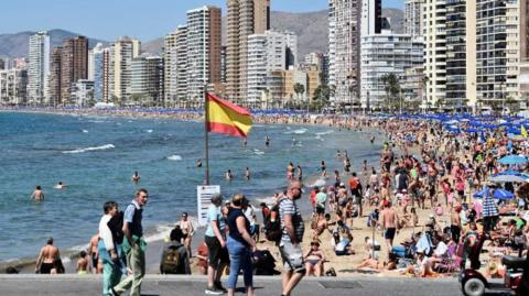 Tourists on a beach in Benidorm